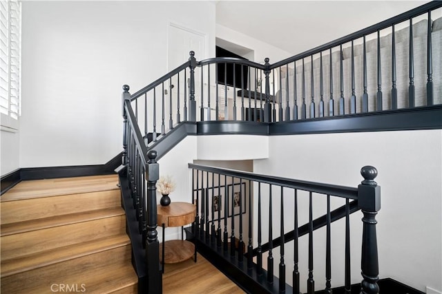 staircase featuring wood finished floors