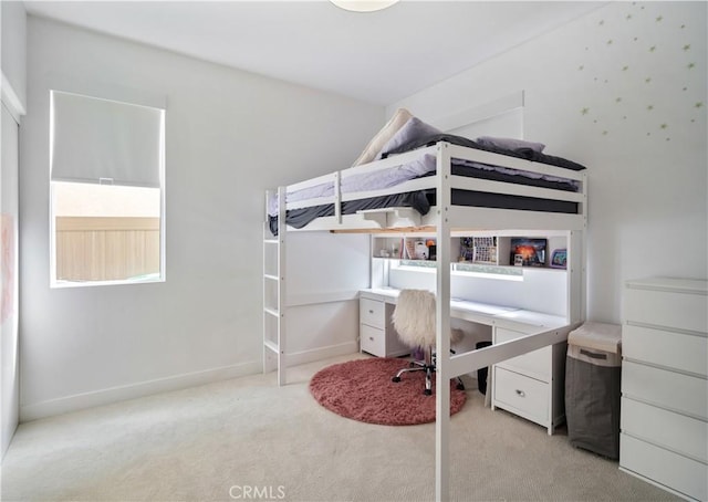 bedroom with carpet floors and baseboards