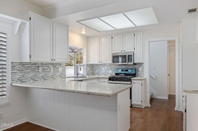 kitchen featuring stainless steel appliances, a sink, and white cabinets