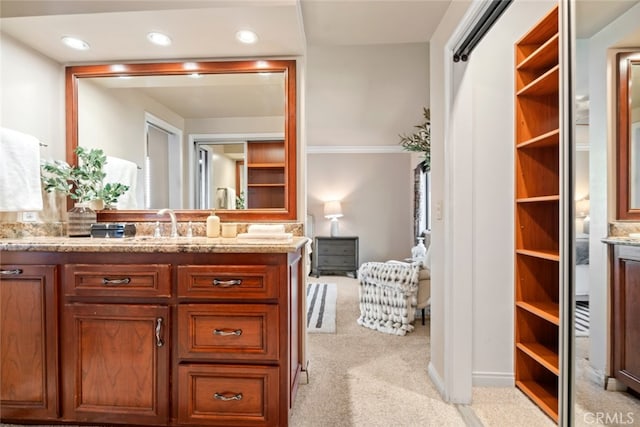 bathroom with recessed lighting and vanity