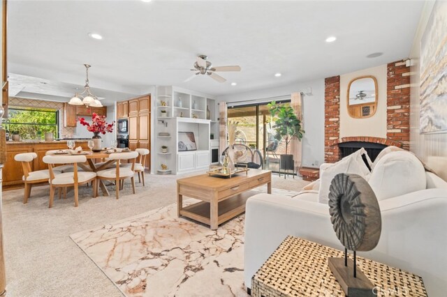 living area with light colored carpet, recessed lighting, a healthy amount of sunlight, and a fireplace