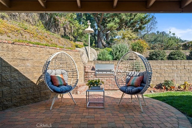 view of patio / terrace with a grill, fence, and an outdoor kitchen