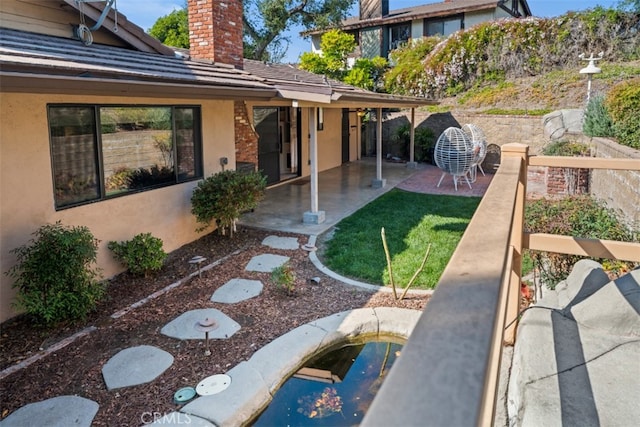 view of yard with a garden and a patio area