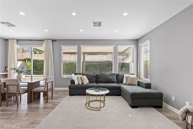 living room featuring visible vents, wood finished floors, and recessed lighting