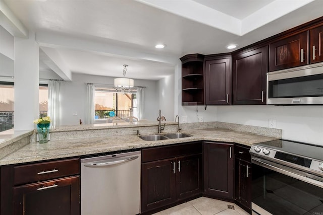 kitchen featuring light tile patterned floors, a sink, dark brown cabinets, appliances with stainless steel finishes, and light stone countertops