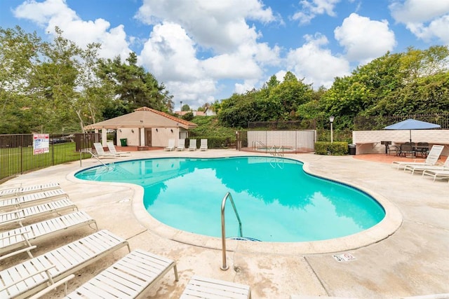 pool featuring a patio area and fence