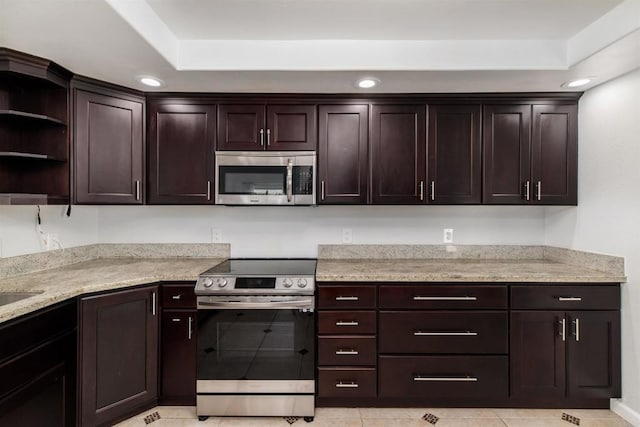 kitchen featuring dark brown cabinetry, recessed lighting, stainless steel appliances, light stone countertops, and open shelves