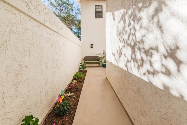 view of property exterior with fence and stucco siding