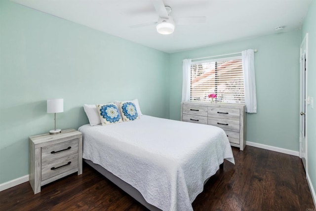 bedroom with dark wood-style floors, baseboards, and a ceiling fan