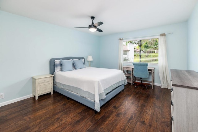 bedroom featuring baseboards, dark wood finished floors, and a ceiling fan