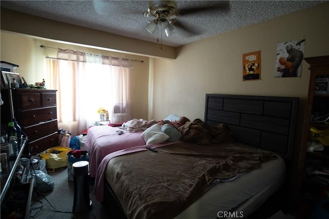 carpeted bedroom featuring a textured ceiling and ceiling fan