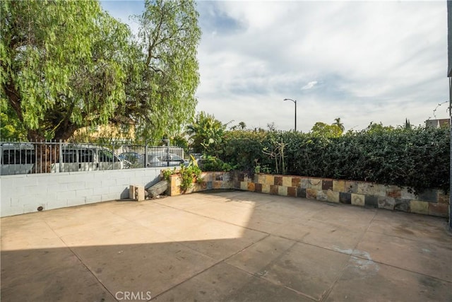view of patio featuring fence