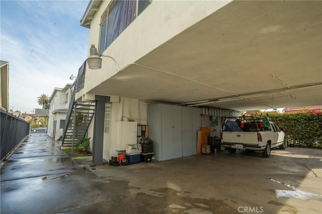 exterior space featuring stucco siding and stairway