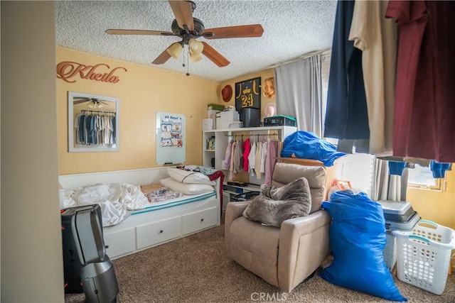 bedroom with carpet, ceiling fan, and a textured ceiling