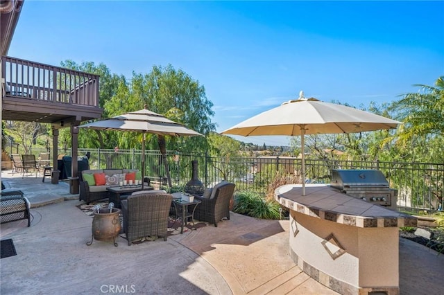 view of patio featuring exterior kitchen, fence, an outdoor living space, and grilling area