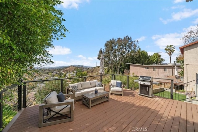 deck with a mountain view, area for grilling, and an outdoor hangout area