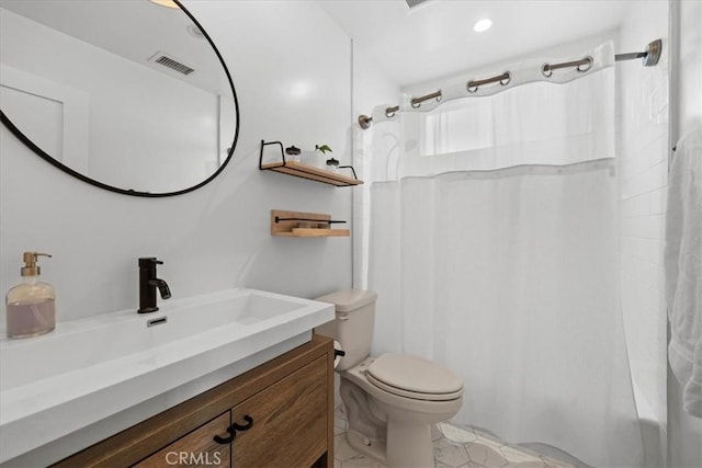 bathroom featuring toilet, vanity, visible vents, and shower / tub combo with curtain