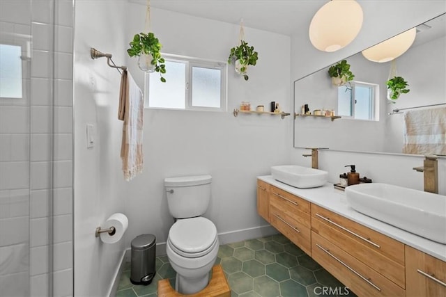 full bathroom with toilet, tile patterned flooring, double vanity, and a sink