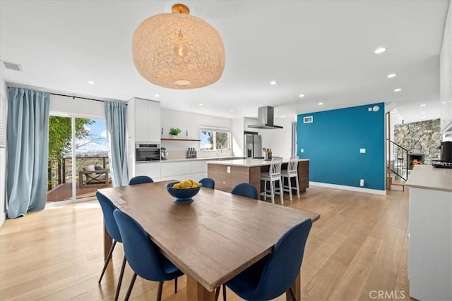 dining area featuring baseboards, recessed lighting, visible vents, and light wood-style floors