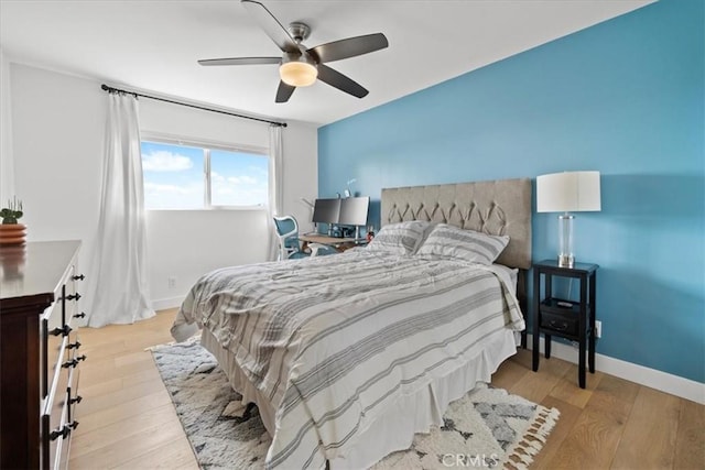 bedroom featuring ceiling fan, baseboards, and hardwood / wood-style floors