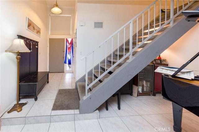 staircase with tile patterned flooring and visible vents