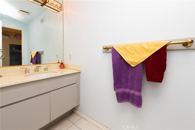 bathroom with tile patterned flooring, visible vents, baseboards, and vanity