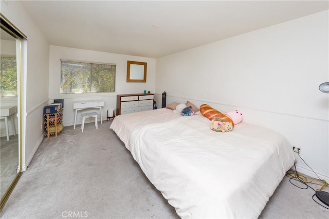 bedroom with light carpet and baseboards