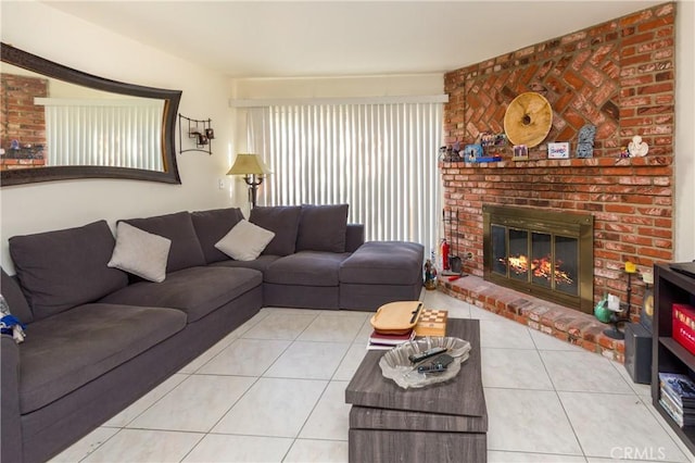 living area with a brick fireplace and tile patterned floors