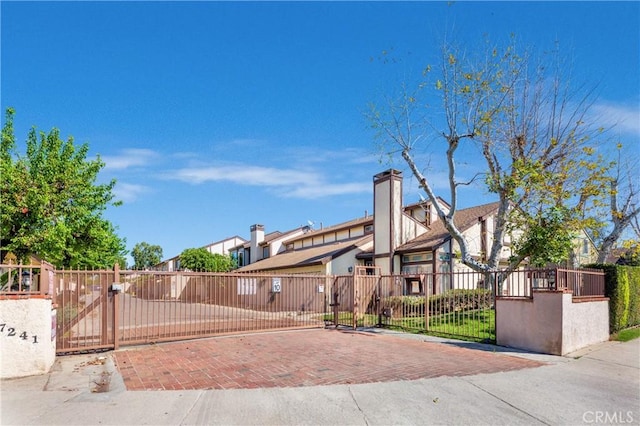 view of front of home with a fenced front yard and a gate