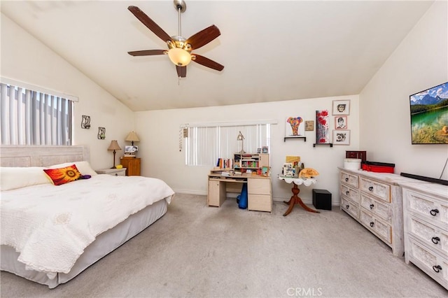 bedroom featuring lofted ceiling, baseboards, a ceiling fan, and light colored carpet