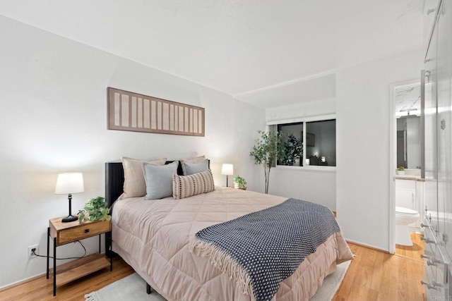 3839 Vista Campana S Unit 32, Oceanside, CA 92057 - bedroom featuring wood finished floors, connected bathroom, and baseboards