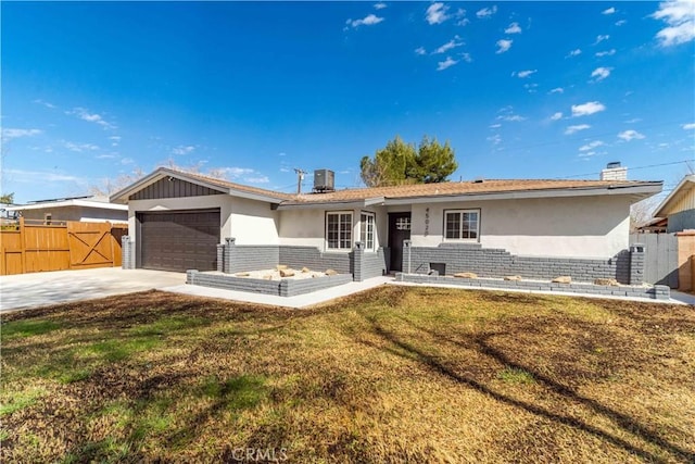 single story home with brick siding, central air condition unit, concrete driveway, fence, and a garage