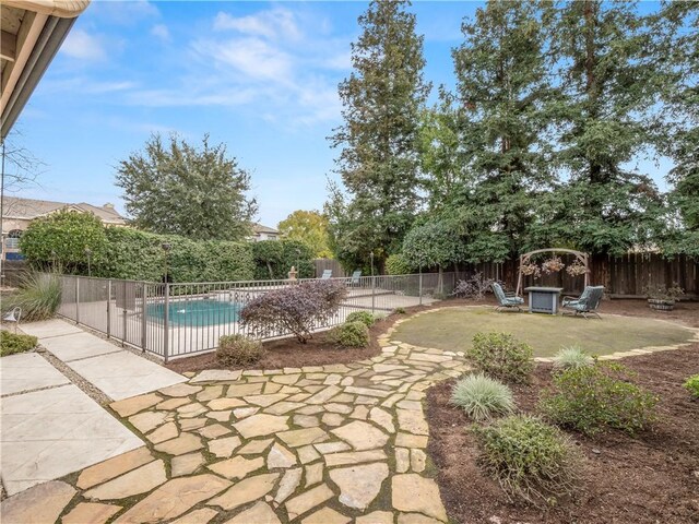 2705 E Ryan Ln, Fresno, CA 93720 - view of swimming pool featuring a patio, a fenced backyard, and a fire pit