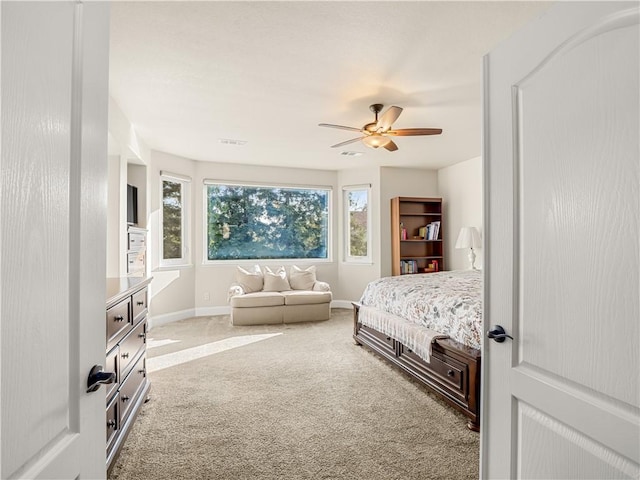 carpeted bedroom with ceiling fan, visible vents, and baseboards