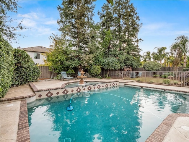 view of pool with a fenced backyard and a patio