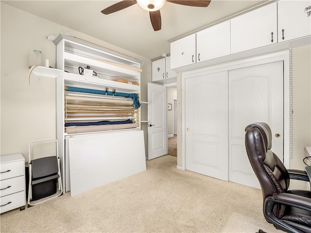 office featuring light carpet and a ceiling fan