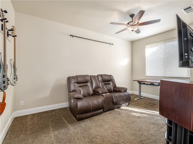 carpeted living room with a ceiling fan, visible vents, and baseboards