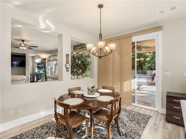 dining room with visible vents, light wood-style flooring, and baseboards