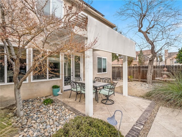 view of patio / terrace featuring fence, a pergola, and outdoor dining space