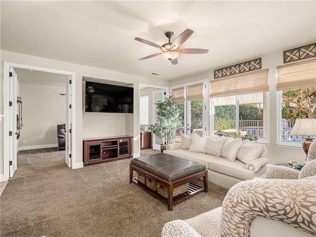 carpeted living area with visible vents, ceiling fan, and baseboards