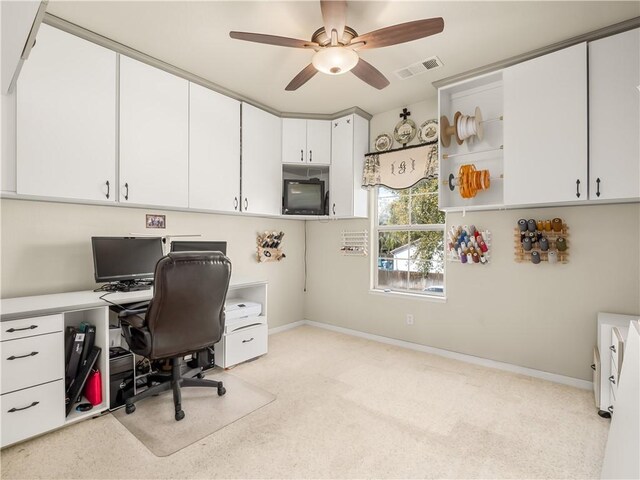 office area with a ceiling fan, light colored carpet, visible vents, and baseboards