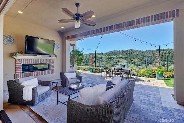 view of patio / terrace featuring outdoor lounge area, outdoor dining area, and a ceiling fan