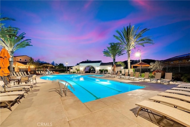 pool featuring fence and a patio area