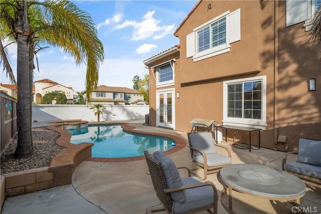 view of pool with a patio, a fenced backyard, french doors, a fenced in pool, and a hot tub