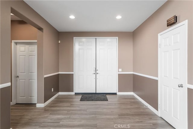 foyer featuring recessed lighting, baseboards, and wood finished floors