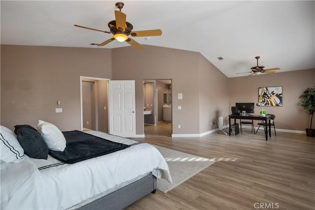 bedroom with light wood-type flooring, visible vents, vaulted ceiling, and baseboards