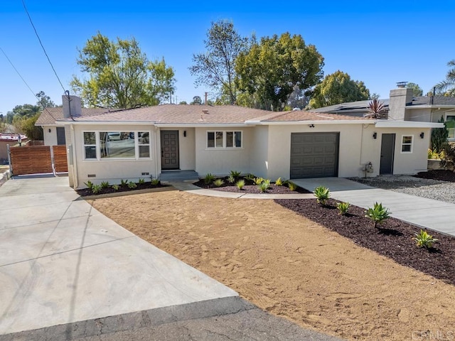 ranch-style home featuring a garage, fence, concrete driveway, stucco siding, and a chimney