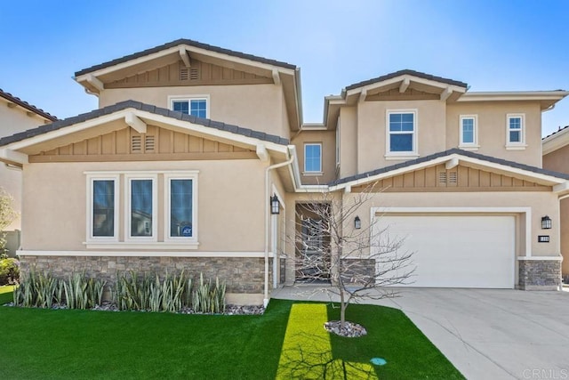 craftsman-style home featuring a front yard, a garage, stone siding, and driveway