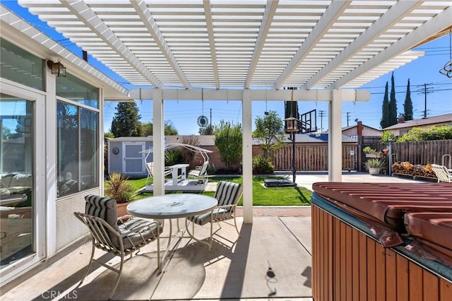 view of patio featuring a fenced backyard, an outbuilding, a storage unit, a pergola, and outdoor dining space