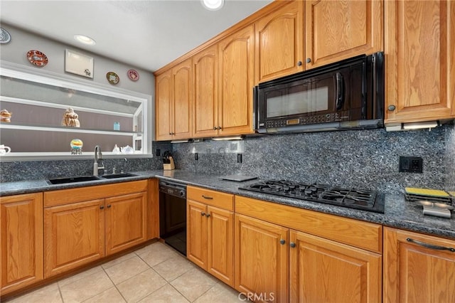 kitchen featuring black appliances, backsplash, light tile patterned flooring, and a sink